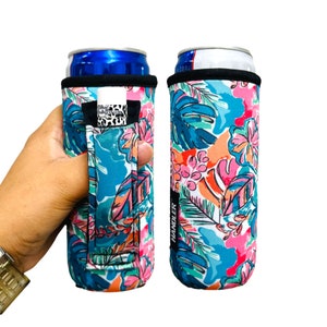 May include: Two colorful neoprene can coolers with a tropical floral print. The cooler on the left has a black handle with the word "HANDLER" printed on it. The cooler on the right has a black handle with the word "HANDLER" printed on it.
