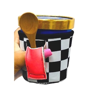 May include: A black and white checkered insulated cup holder with a pink and red pocket for a spoon. The holder is designed to keep ice cream cold and has a built-in spoon holder.
