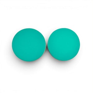 May include: Two teal-colored, round earrings against a white background. The earrings have a smooth, matte finish and a simple, minimalist design. The earrings are a vibrant, solid color.