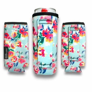 May include: Three blue and white floral print neoprene can coolers with black handles and the text "DRINK HANDLERS" on one cooler.