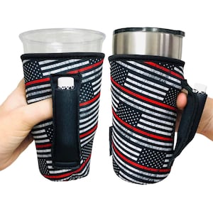 May include: Two beverage holders with a black, white, and red American flag design. One holder has a clear plastic cup, the other a stainless steel tumbler. Both have a black handle and a small pocket.