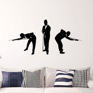 May include: Black and white silhouette wall decal of three people playing pool. The figures are in various poses, one standing and two bending over to take a shot.
