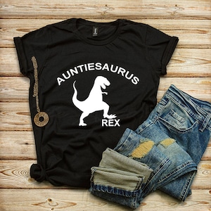 May include: Black t-shirt with a white dinosaur silhouette and the text "Auntiesaurus Rex".