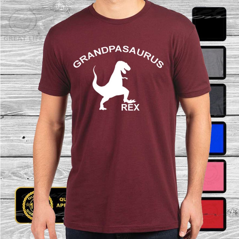 May include: Burgundy t-shirt with a white graphic of a dinosaur with the text "Grandpasaurus Rex".
