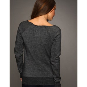 May include: A charcoal gray long-sleeved sweatshirt with a relaxed fit and a slightly off-the-shoulder neckline. The sweatshirt has a distressed look around the neckline.