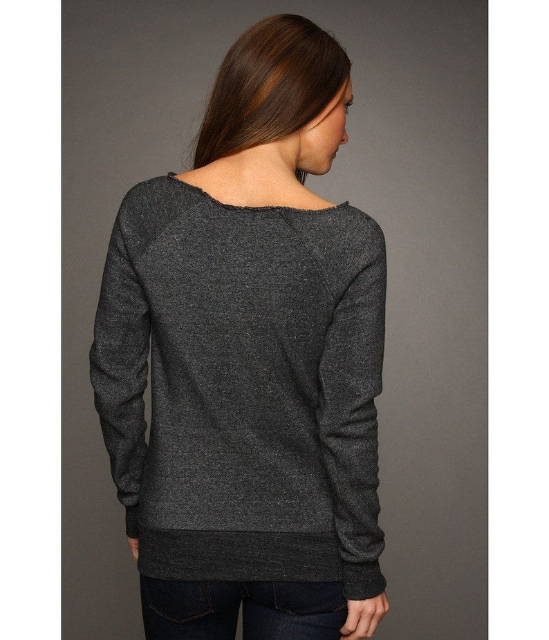 May include: A charcoal gray long-sleeved sweatshirt with a relaxed fit and a slightly off-the-shoulder neckline. The sweatshirt has a distressed look around the neckline.