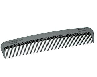 May include: A gray comb with the text "Chicago Comb Co." and "Model No. 3 CARBON FIBER" printed on it.