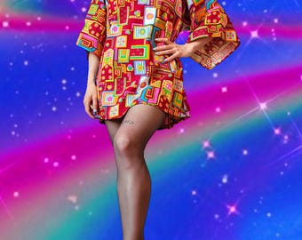 May include: A vibrant, short-sleeved dress in a bold, geometric pattern of red, orange, yellow, green, and blue. The dress features a round neckline and a flared hemline. The background is a colorful, abstract design with a rainbow gradient.