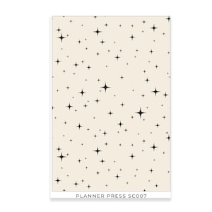 May include: A rectangular planner with a cream-colored background and a pattern of black star shapes. The text "PLANNER PRESS SC007" is printed at the bottom. The stars vary in size and are evenly distributed across the surface.