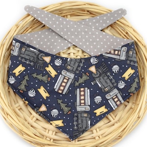 May include: A navy blue bandana with a white polka dot reverse side. The bandana features a repeating pattern of a train, Christmas trees, and ornaments.