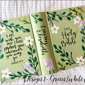 May include: A light green Bible cover with white floral accents and the text "I AM with you, AND I WILL protect you wherever you may go." The spine reads "Lauren Elizabeth" and "THE Holy Bible."
