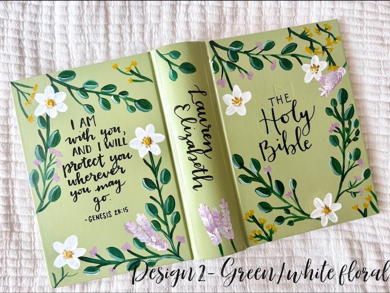 May include: A light green Bible cover with white floral accents and the text "I AM with you, AND I WILL protect you wherever you may go." The spine reads "Lauren Elizabeth" and "THE Holy Bible."
