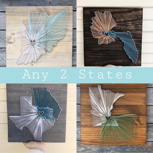 May include: Four wooden signs with string art of different states. The signs are all the same size and have a dark wood background. The string art is in different colors, including blue, green, white, and brown. The text "Any 2 States" is written on a blue banner across the middle of the image.