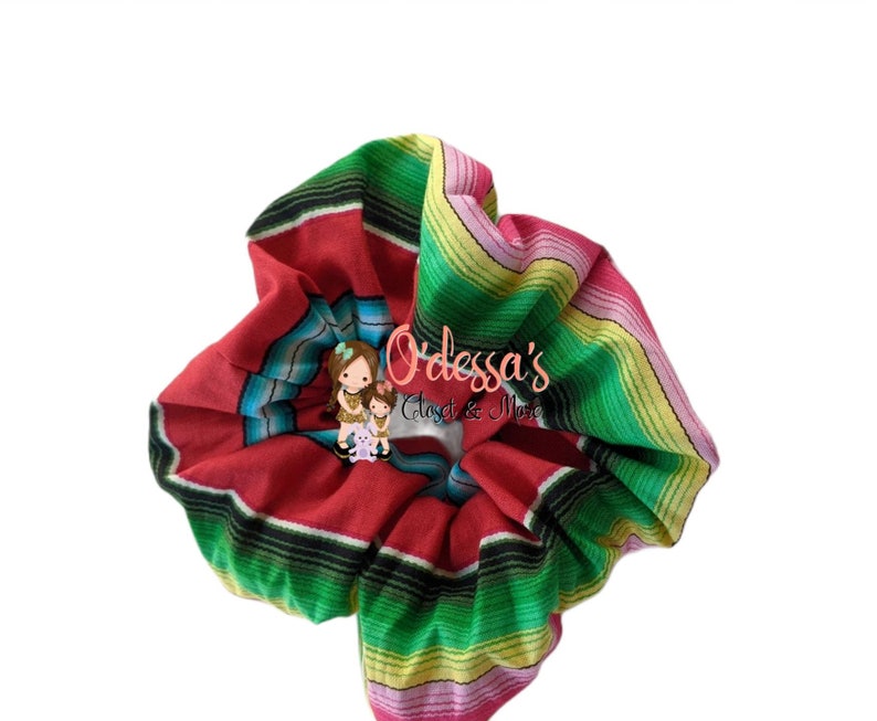 May include: A red, green, yellow, and pink striped scrunchie with the text "Odessa's Closet & More" in black.