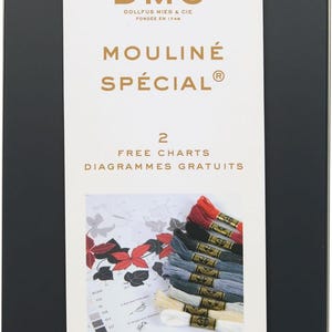 May include: A black tin box with a white label containing DMC Mouline Special embroidery floss. The label features the DMC logo, the text "Mouline Special", and "2 Free Charts". The box contains 24 skeins of floss, each 8.7 yards long.