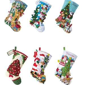 May include: Six felt Christmas stockings with various holiday themes and personalized names. The stockings feature a snowman, Santa Claus, a Christmas tree, a reindeer, and a scene from the Wizard of Oz.