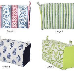 May include: Four different fabric cosmetic bags, two small and two large. The small bags are blue and white with floral patterns, and the large bags are green and white with striped and floral patterns. The bags have zipper closures and fabric handles.