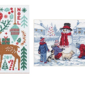 May include: Two cross-stitch patterns featuring winter scenes. The first pattern shows a reindeer carrying a gift box with a red heart, a Christmas tree, and the word "NOEL" in the background. The second pattern shows three children building a snowman with a dog watching.