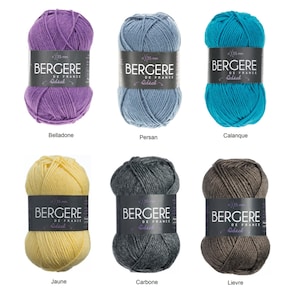 May include: Six balls of yarn in different colors: purple, blue, yellow, gray, and brown. Each ball has a label that says "Bergère de France Ideal" and the size of the yarn is 3.5 mm.
