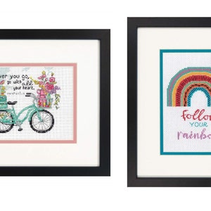 May include: Two framed cross-stitch embroidery designs. The first design features a bicycle with flowers and the text "wherever you go, go with all your heart." The second design features a rainbow with the text "follow your rainbow."