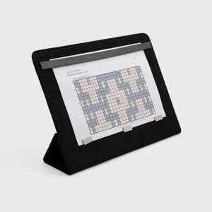 May include: Black suede easel with a metal clip holding a printed crossword puzzle. The puzzle is titled "Scenery Knitting - Printed Flower Cover - Pressed Flowers 4".