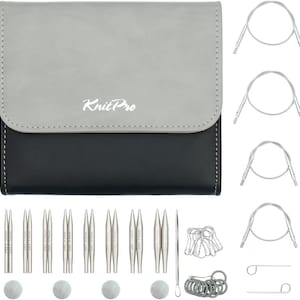 May include: A knitting needle set with a grey and black case, featuring the Knit Pro logo. The set includes various sizes of silver-coloured needles, circular cables, stitch markers, and other knitting accessories. The case is closed.