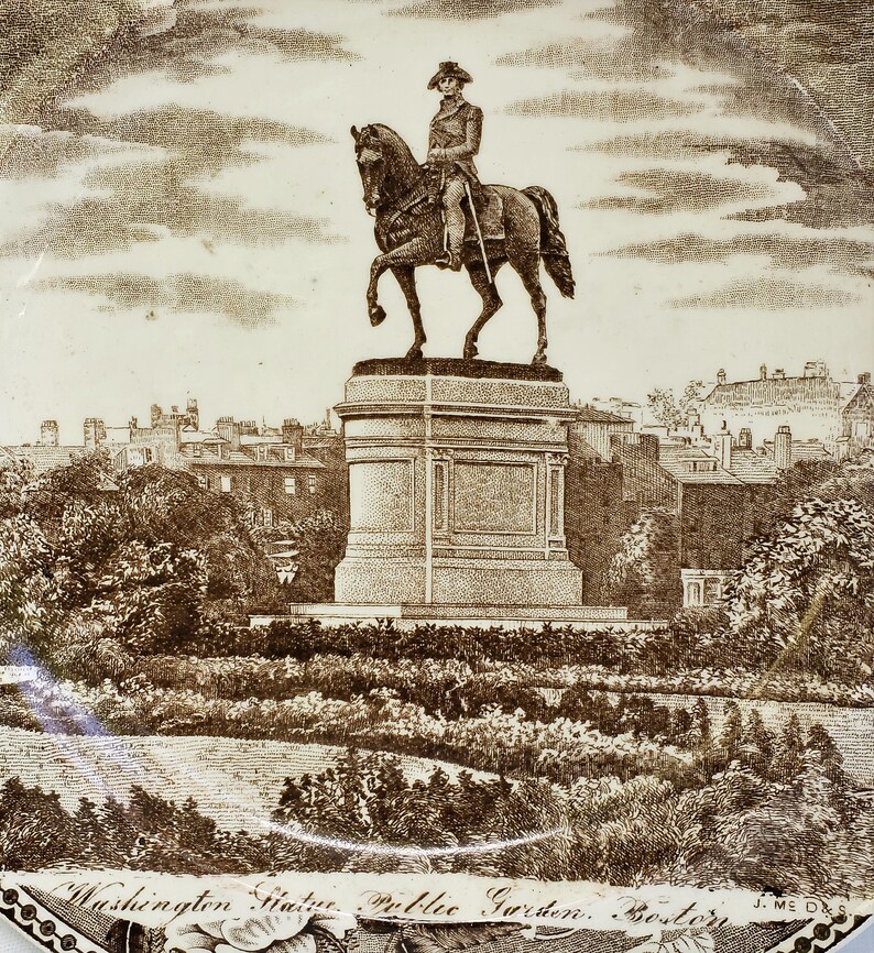 May include: A black and white engraving of a statue of George Washington on horseback in the Public Garden in Boston, Massachusetts. The statue is on a pedestal and surrounded by trees and bushes. The text "Washington Statue. Public Garden. Boston." is at the bottom of the image.