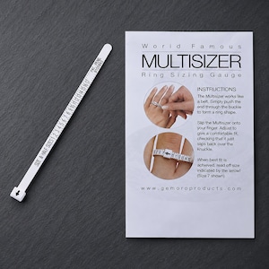May include: A white plastic Multisizer ring sizing gauge with black numerical markings from 1 to 17 and half sizes, accompanied by a white instructional card titled World Famous MULTISIZER Ring Sizing Gauge with diagrams and text.