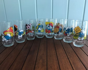 One 1982 Smurf Hardee’s Collector Glass - Hefty Smurf, Grouchy Smurf, Brainy Smurf, Jokey Smurf, Lazy Smurf, Papa Smurf, Smurfette, Gargamel