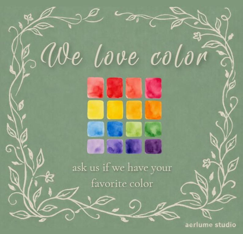 May include: A sage green graphic featuring the text We love color and ask us if we have your favorite color. A grid of sixteen watercolor squares in red, orange, yellow, green, blue, and purple hues is centered within a white vine border.