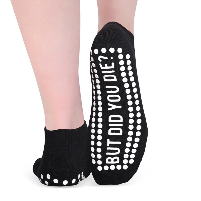 May include: Black ankle socks with white grip dots on the bottom and the text "BUT DID YOU DIE?" printed on the back of the sock.