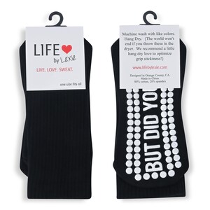 May include: A pair of black socks with white grip dots and the text "BUT DID YOU" on the bottom. The socks are packaged with a white card that says "LIFE by Lexie LIVE. LOVE. SWEAT. one size fits all".