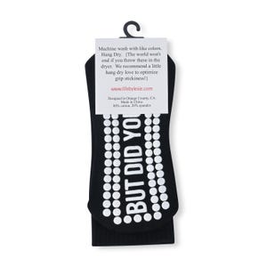 May include: Black socks with white polka dots and the text "BUT DID YOU" printed on them. The socks are packaged with a white tag that includes care instructions and the website address.
