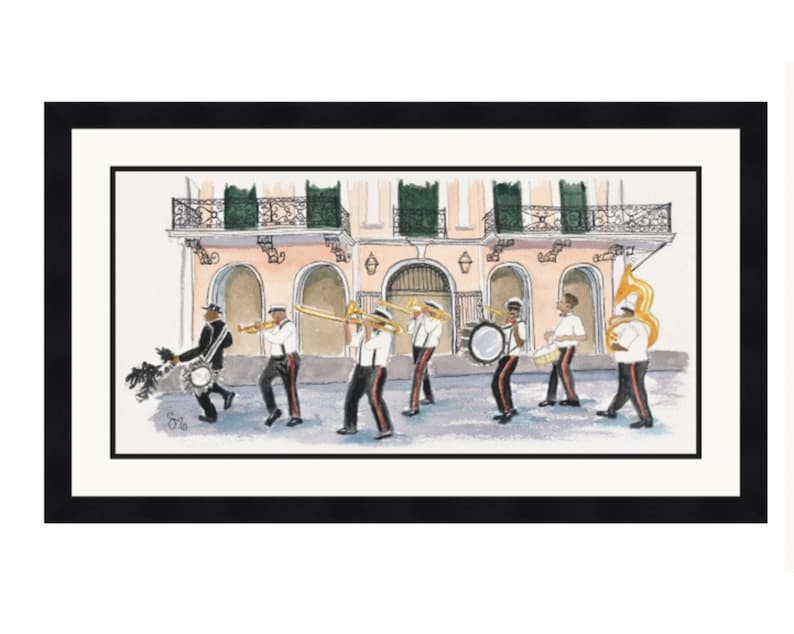 May include: A watercolor painting of a New Orleans brass band marching down a street. The band is made up of seven musicians, all wearing white shirts and black pants. They are playing trumpets, trombones, drums, and a tuba. The band is marching in front of a pink building with arched doorways. The painting is framed in black.