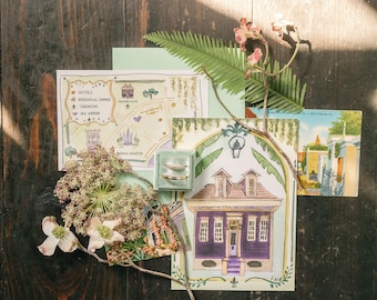 May include: A hand-drawn map of New Orleans with a green and yellow color scheme. The map includes the French Quarter, hotels, and locations for a wedding ceremony and rehearsal dinner. A small blue box with two gold rings is in the lower right corner of the image.