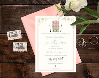 May include: Wedding invitation with a pink envelope, two stamps, and rings on a wooden surface. The invitation features a watercolor illustration of a building and text that reads "Natalie Lynn Misasi and Jarrod Midgul White".