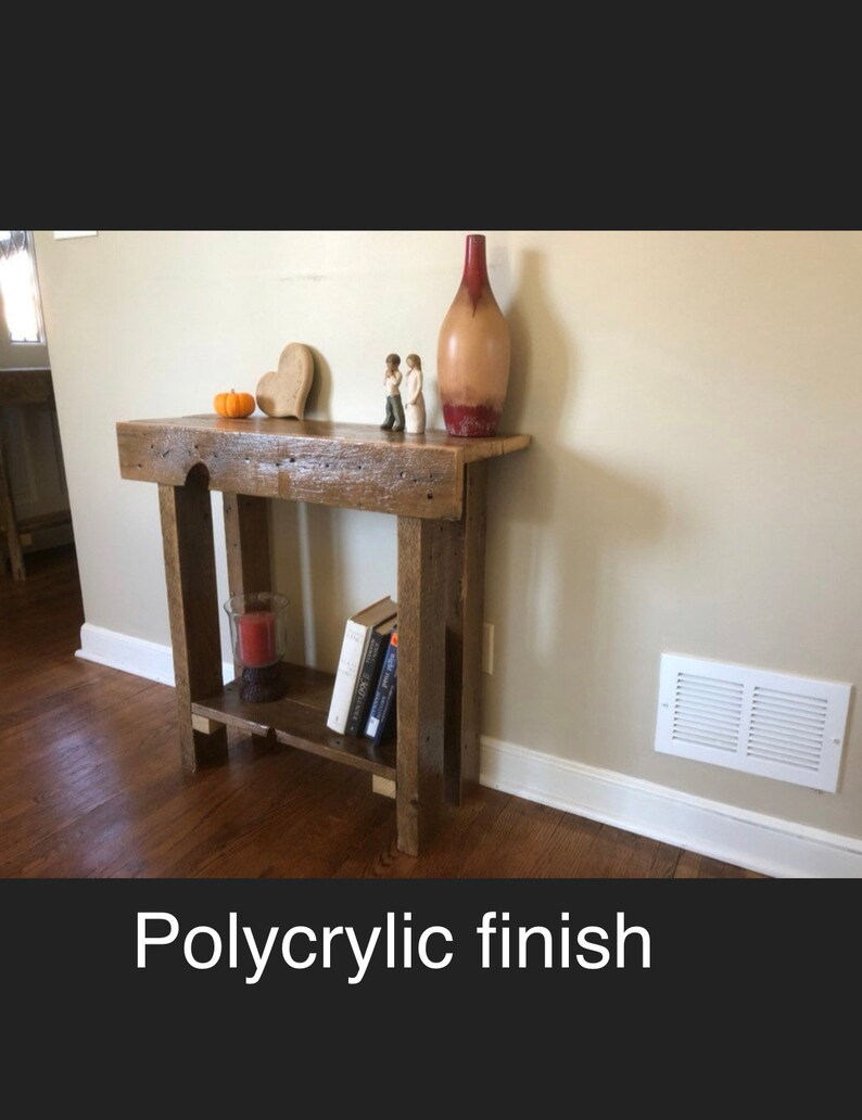 May include: A rustic wooden console table with a shelf, featuring a polycrylic finish. The table is decorated with a vase, a heart-shaped ornament, and two figurines.