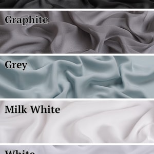 May include: A vertical collage of five fabric swatches in varying colors, each labeled with text. The colors include black, graphite, grey, milk white, and white. Each section displays a soft, draped textile with a smooth, semi-sheer appearance.