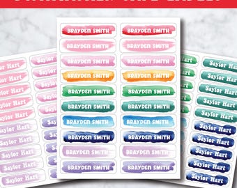 May include: A sheet of rectangular dishwasher safe labels featuring watercolor-style brush strokes in various colors. The labels display the names Brayden Smith and Saylor Hart in white capital letters. The text Dishwasher Safe Labels is at the top.