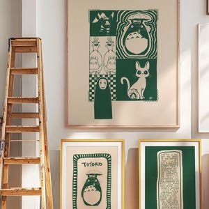 May include: A collection of framed art prints featuring green and white illustrations. The prints showcase characters and scenes from a popular animated film. The frames are gold and the artwork is displayed against a neutral wall.