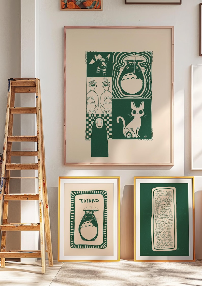 May include: A collection of framed art prints featuring green and white illustrations. The prints showcase characters and scenes from a popular animated film. The frames are gold and the artwork is displayed against a neutral wall.
