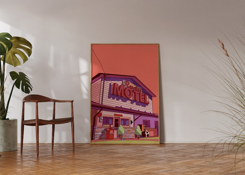 May include: A framed art print featuring a retro illustration of a motel with the name "Reeds" in a neon sign. The artwork has a pink and purple color scheme, with a wooden frame. The print is displayed on a wooden floor.