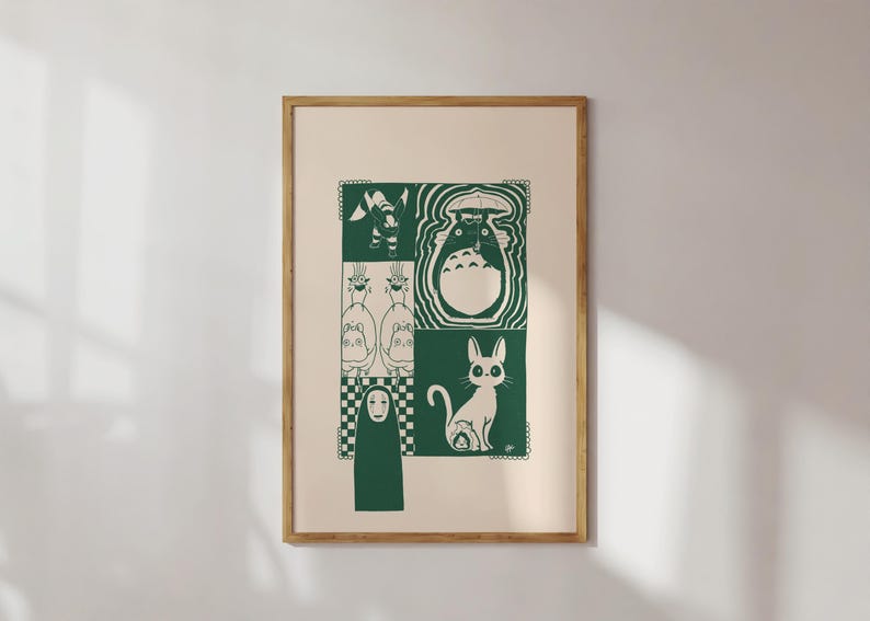 May include: A framed print featuring a green and white illustration of characters from a popular animated film. The artwork is divided into squares, showcasing a variety of figures, including a cat, a forest spirit, and other whimsical creatures. The frame is a light brown color.