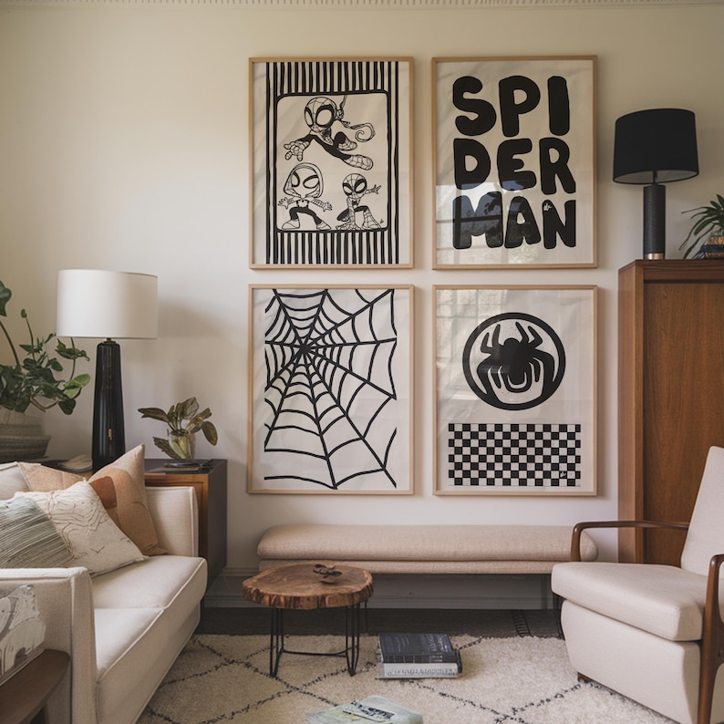 May include: Four framed art prints featuring Spider-Man themes. One print displays the word "SPIDERMAN" in bold black letters. Other prints show a spider web, a spider symbol, and a cartoon illustration of Spider-Man.