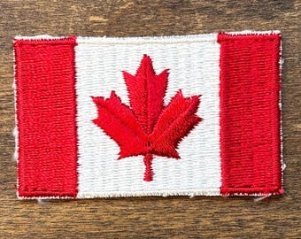 Parche de recuerdo de viaje vintage con la bandera canadiense de Voyager