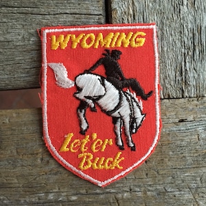 Wyoming Let&#39;er Buck Vintage Souvenir Travel Patch from Voyager - New In Original Package