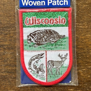 May include: A red, white, and green woven patch with the word "Wisconsin" in red letters. The patch features a badger, a fish, and a deer.