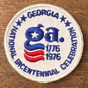 May include: Circular patch with white border and text "GEORGIA NATIONAL BICENTENNIAL CELEBRATION." The patch features a blue "Ga." with a star, red and blue stripes, and the dates "1776 1976."