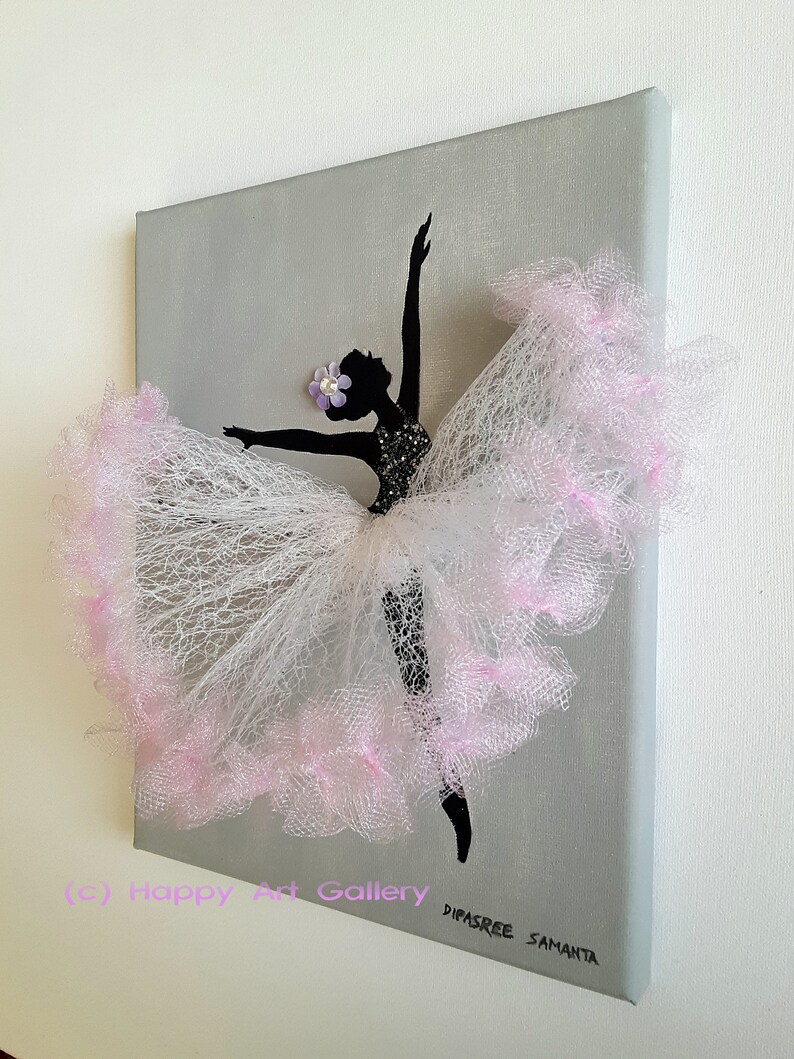 May include: A black silhouette of a ballerina with a pink tulle skirt and a purple flower on her head. The ballerina is painted on a gray canvas.