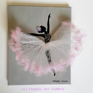 May include: A gray canvas painting of a ballerina silhouette with a pink tulle skirt. The ballerina is wearing a flower on her head and the painting is signed "Dipasree Samanta" and "(c) Happy Art Gallery".